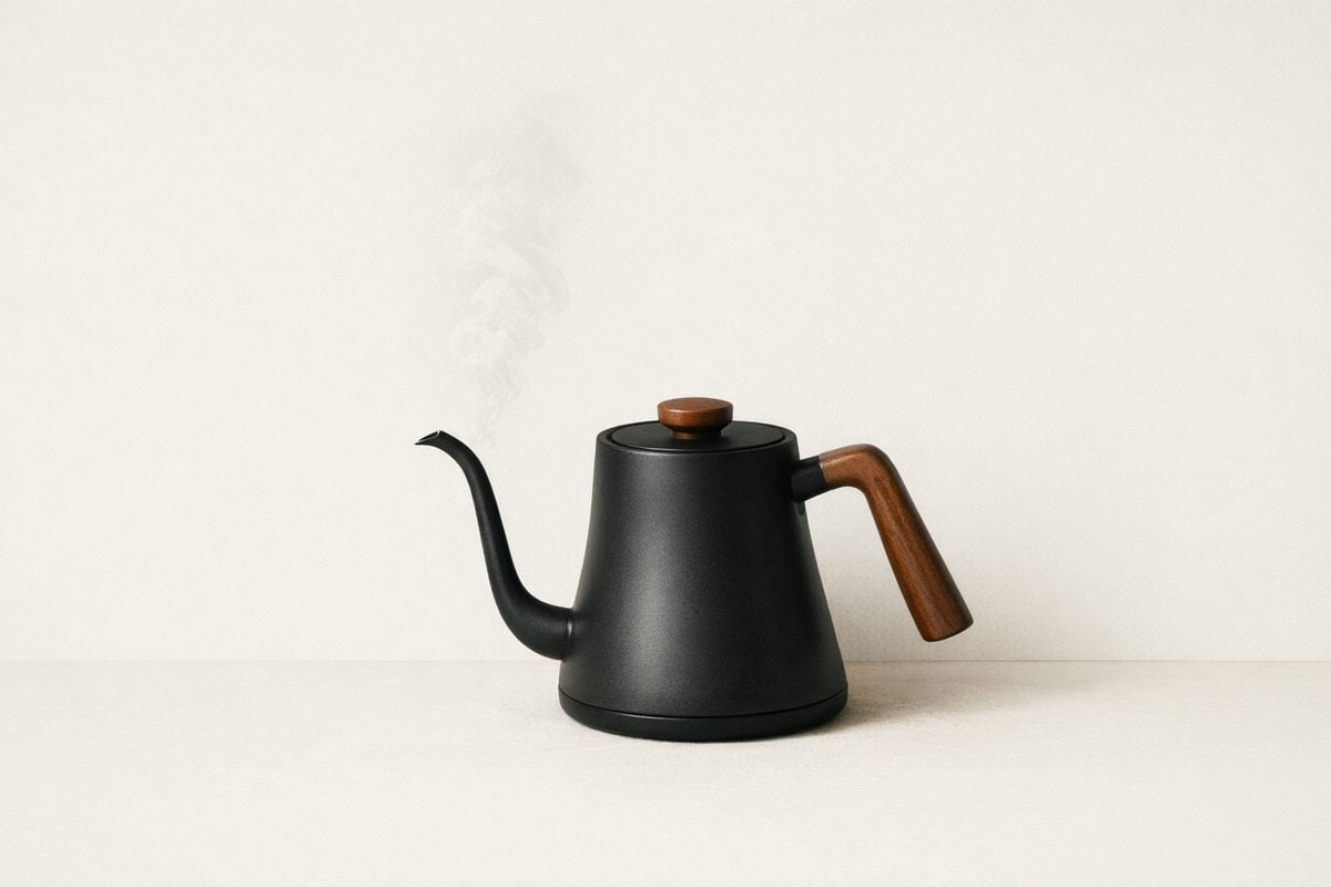 Minimal coffee gear on a warm neutral background. Soft morning light.